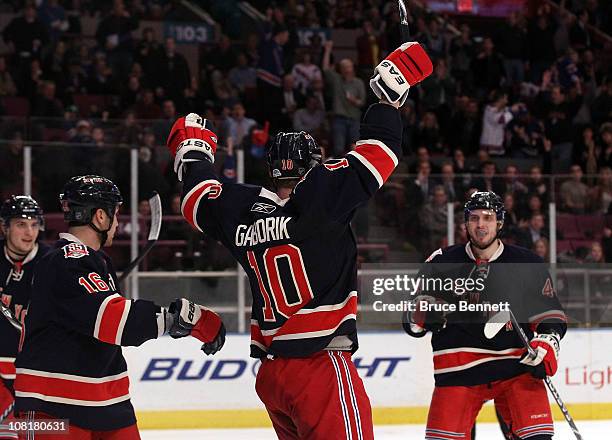 Sean Avery of the New York Rangers and Steve Eminger help Marian Gaborik celebrate his hat trick goal against the Toronto Maple Leafs at Madison...