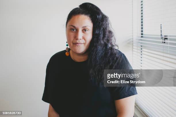 aboriginal woman by an office window - aboriginal woman stock-fotos und bilder