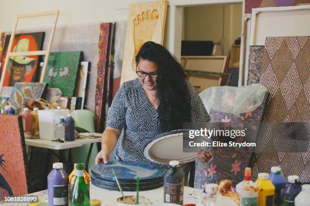 aboriginal woman in art studio - aboriginal artwork stockfoto's en -beelden