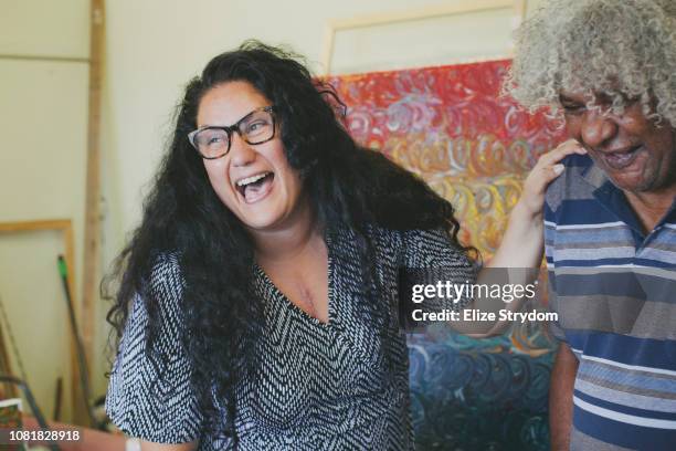 aboriginal woman in art studio - australian aboriginal stock pictures, royalty-free photos & images