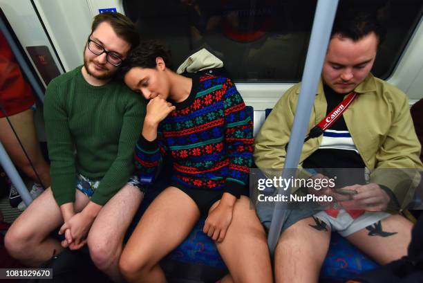 People take part in the annual 'No Trousers On The Tube Day' on the London Underground Jubilee Line, posing for photographs at Canary Wharf, in...