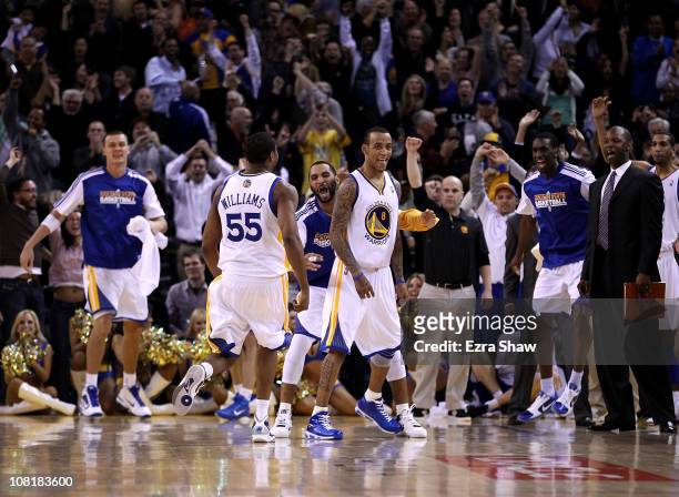 Monta Ellis of the Golden State Warriors is congratulated by teammates after he made the winning shot with 0.6 seconds left in their game againsts...