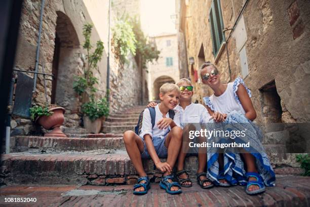 drei kinder spaß sightseeing charmante italienische stadt - dreiviertel vorderansicht stock-fotos und bilder