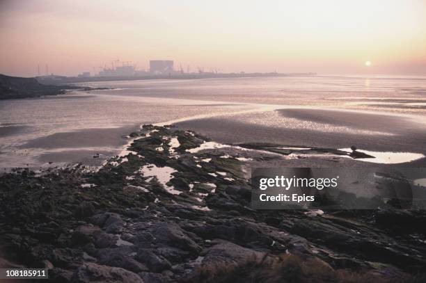 General view of the mud flats and the Heysham nuclear power stations in the background near the coastal village of Heysham, Lancashire, December 1982.