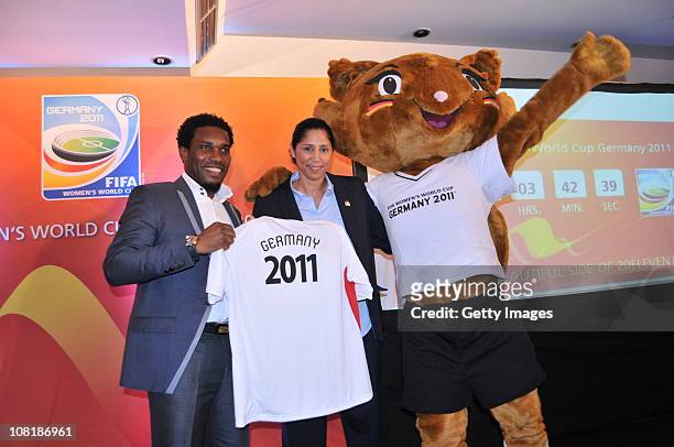 Steffi Jones , FIFA Women's Organising Committee President, poses with Jayjay Okocha and mascot Karla Kick during a press conference of the FIFA...