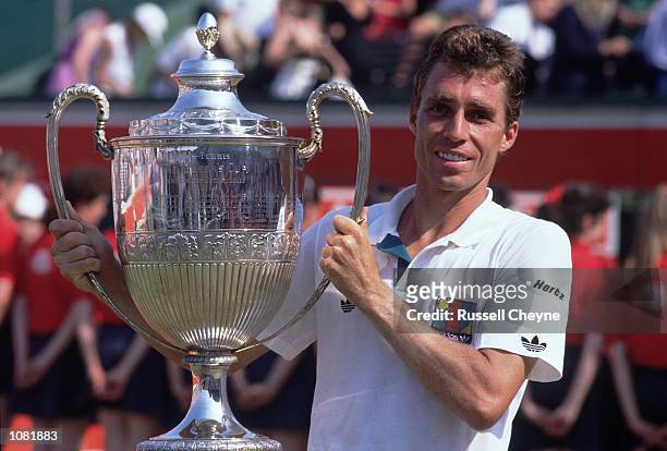 Ivan Lendl of Czechoslovakia poses with the winning trophy after winning the Stella Artois Championships held at the Queens Club, in London. \...