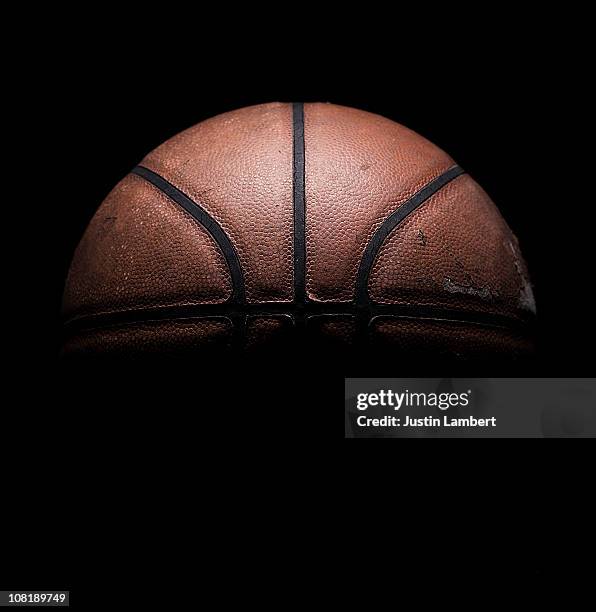 old used basketball on black - basket foto e immagini stock