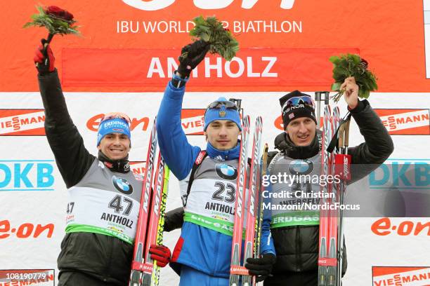 Michael Greis of Germany celebrates with Anton Shipulin of Russia and Lars Berger of Norway after the men's sprint during the E.ON IBU Biathlon World...