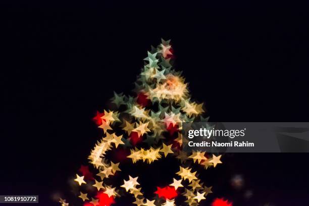 starry lights on a christmas tree - christianity black background stock pictures, royalty-free photos & images