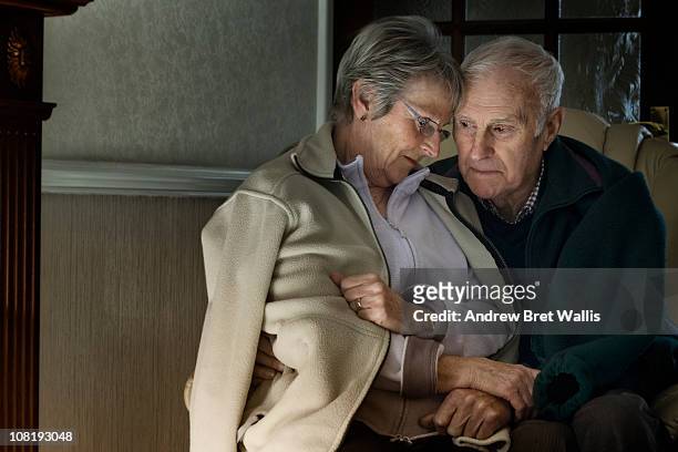 senior couple feeling cold in their home - hull uk stock pictures, royalty-free photos & images
