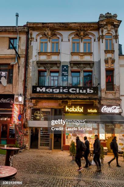 People walk on Strada Selari in front of a crumbling house in the Centru Vechi on December 7, 2018 in Bucharest, Romania. Bucharest's Old Town is...