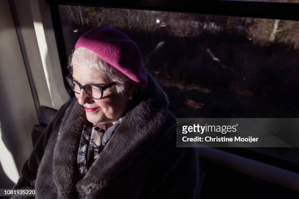 Independent older woman using public transport