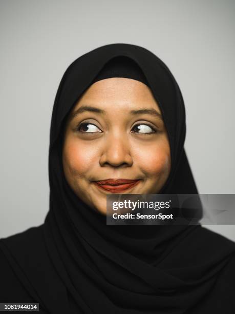 real happy young woman with hijab looking to the side - looking around stock pictures, royalty-free photos & images