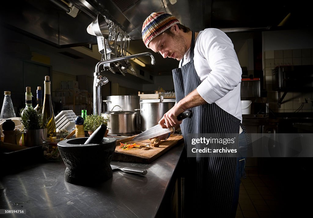 A cook preparing a meal in the dark