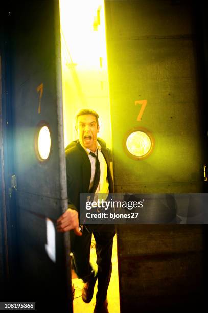 businessman screaming and running through a pair of doors - spåra bildbanksfoton och bilder