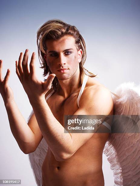 male angel holding arms up - man angel wings stock pictures, royalty-free photos & images