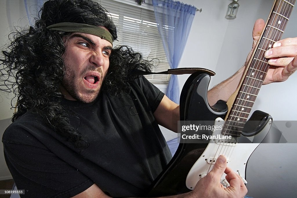 Heavy Metal Rocker in Bedroom with Electric Guitar