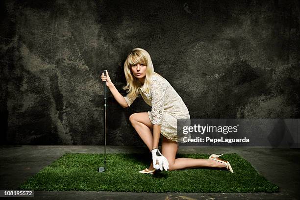 young woman posing on turf grass with golf club - gag ball stock pictures, royalty-free photos & images
