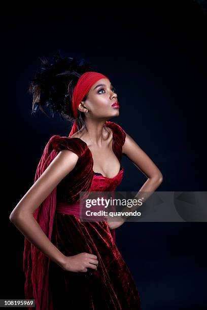 african american fashion model in long red gown, on black - haute couture dress stock pictures, royalty-free photos & images
