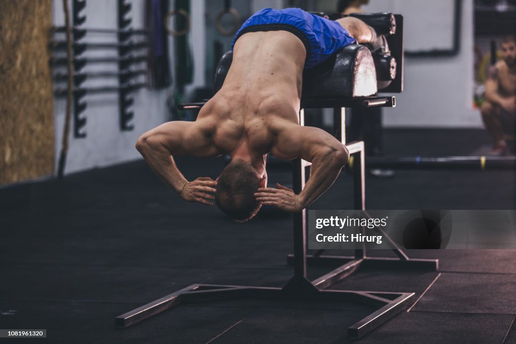 Low back exercising on roman bench at the gym