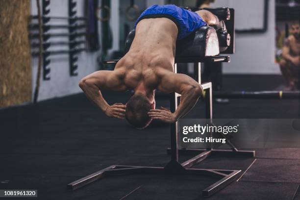 low back exercising on roman bench at the gym - low motivation stock pictures, royalty-free photos & images