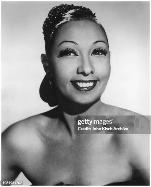 Publicity still portrait of American singer Josephine Baker, in a strapless dress, France, 1949.