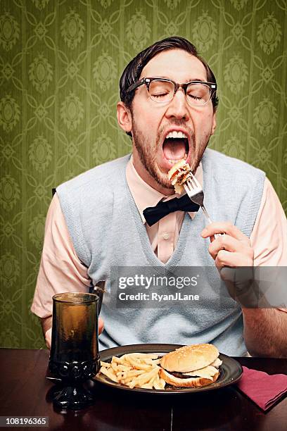 nerd young man eating dinner - deep fried bildbanksfoton och bilder