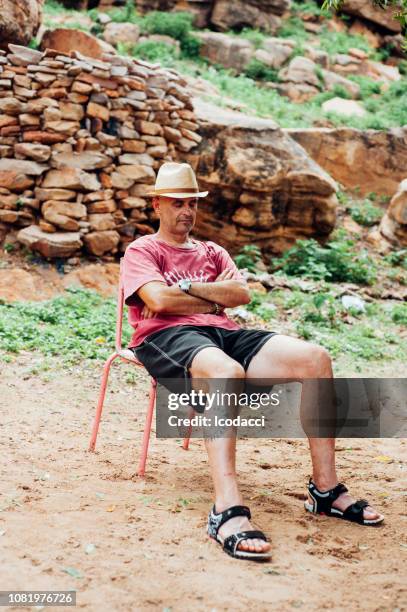 white caucasian people and black african people enjoy life in a rural village. - for freedom and peace in mali stock pictures, royalty-free photos & images