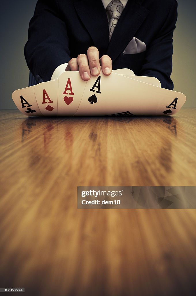 Businessman Showing Card Hand of Aces