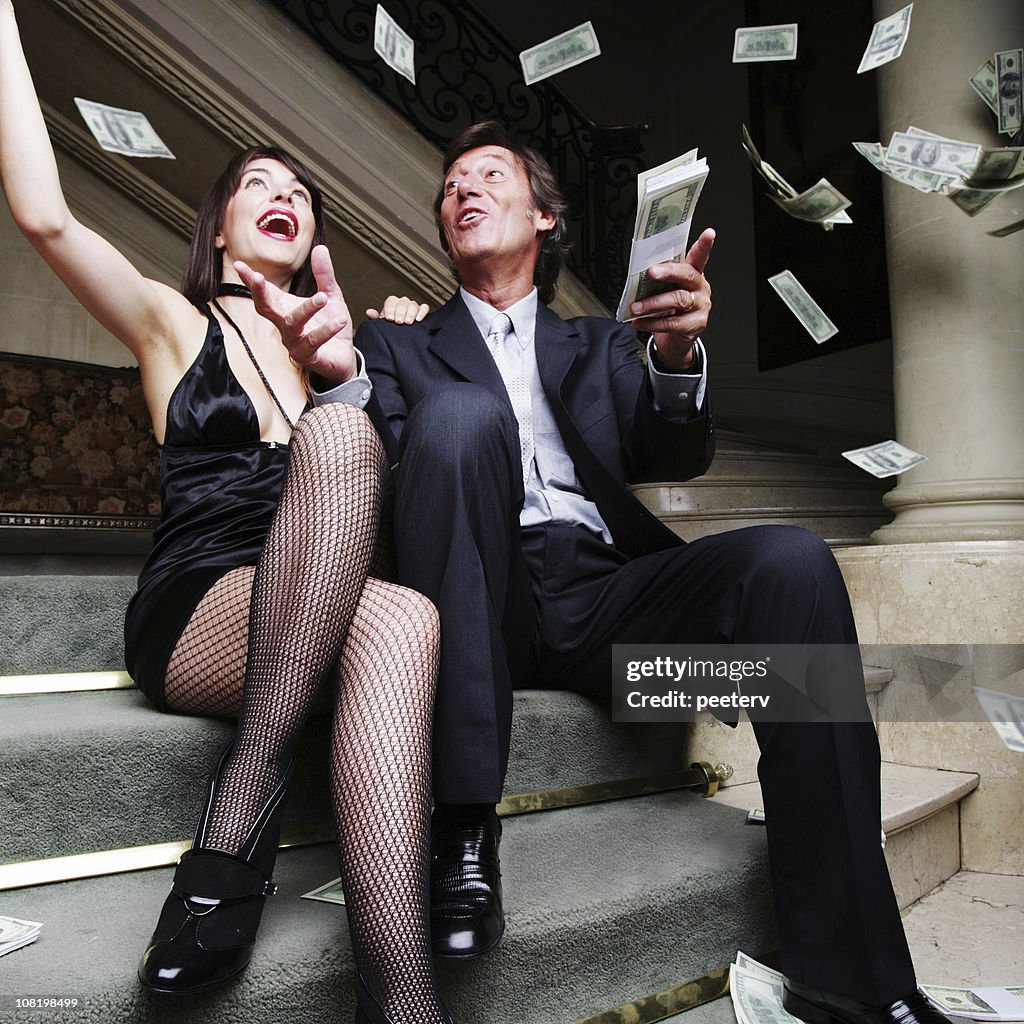 Couple Throwing Money in the Air