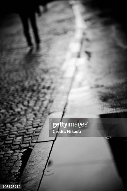 rainy street - cobblestone puddle stock pictures, royalty-free photos & images