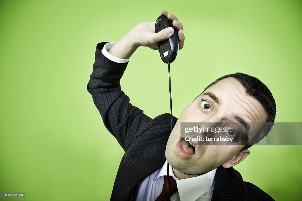 Desperate Businessman Strangling Himself with Computer Mouse