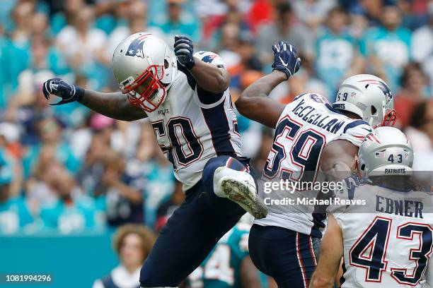Ramon Humber and Albert McClellan of the New England Patriots celebrate a touchdown against the Miami Dolphins at Hard Rock Stadium on December 9,...