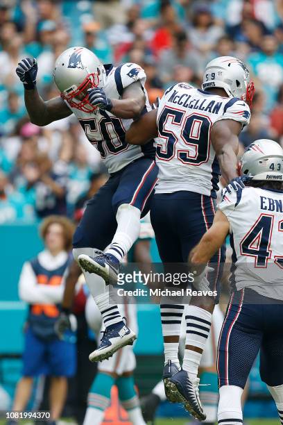Ramon Humber and Albert McClellan of the New England Patriots celebrate a touchdown against the Miami Dolphins at Hard Rock Stadium on December 9,...