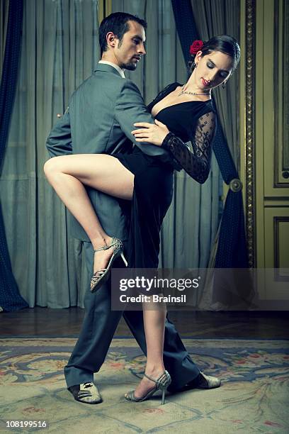 young couple dressed up and doing tango dance - tango black stock pictures, royalty-free photos & images