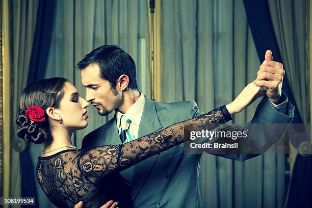 young couple dancing tango in room - tango black stock pictures, royalty-free photos & images