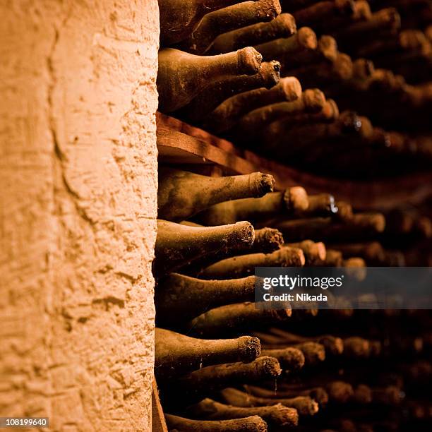 wine bottles in cellar - cellar stock pictures, royalty-free photos & images