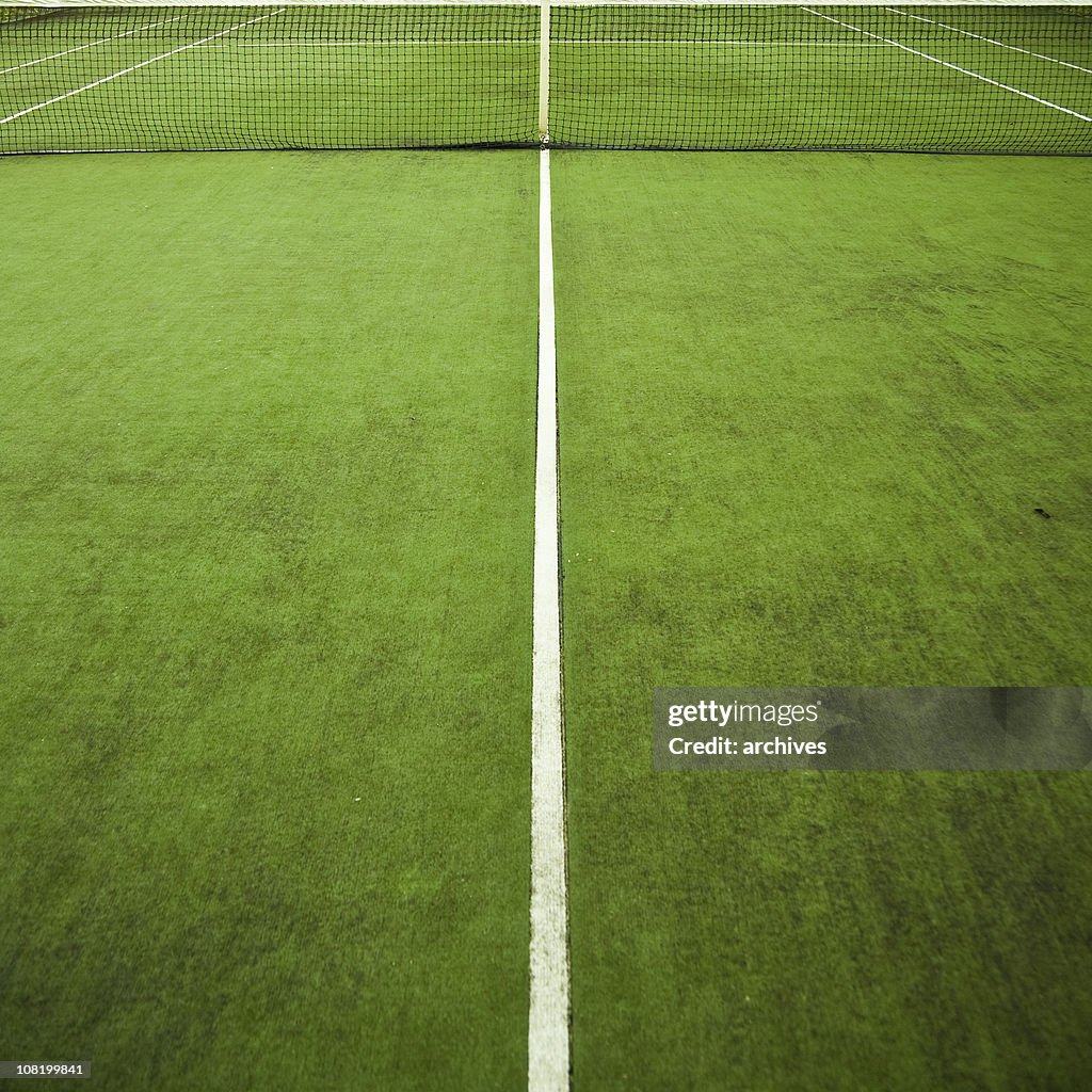 Green Tennis Court with Net and White Lines