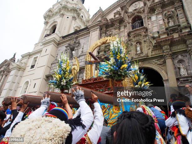 Devotees carrying a religious litter when hundreds of Quechua-speaking Indigenous people, devotees of San Sebastian, carry on a religious procession...