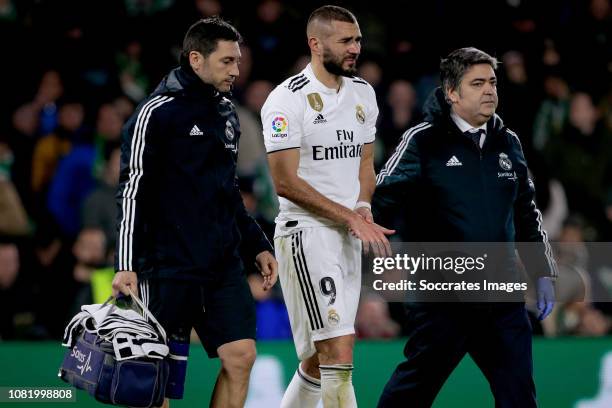 Karim Benzema of Real Madrid is leaving the pitch injured during the La Liga Santander match between Real Betis Sevilla v Real Madrid at the Estadio...