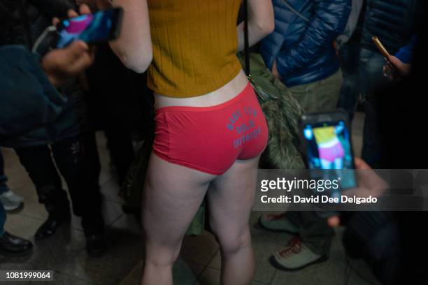 Woman is photographed by straphangers during the 18th annual No Pants subway ride on January 13, 2019 in New York City. 24 cities participate in the...