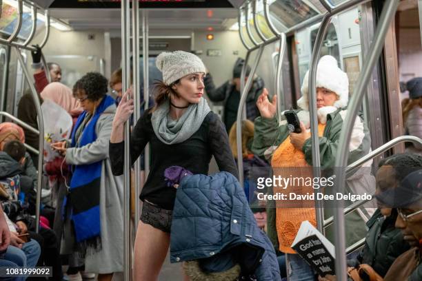 Woman rides the F subway line during the 18th annual No Pants subway ride on January 13, 2019 in New York City. 24 cities participate in the annual...
