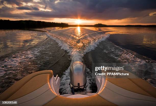 sunset - motor boat stock pictures, royalty-free photos & images
