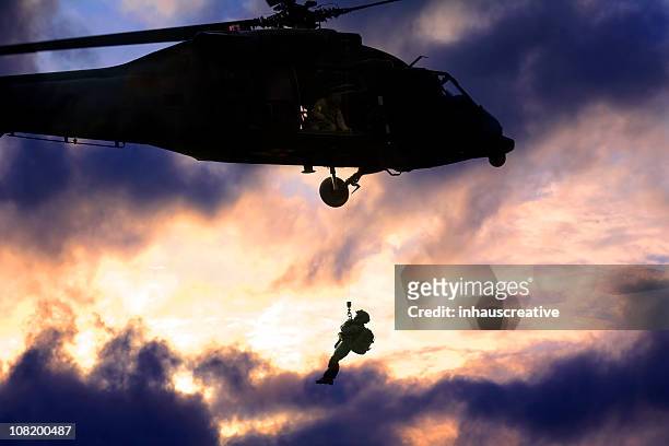military blackhawk helicopter rescuing a soldier - national guard stock pictures, royalty-free photos & images