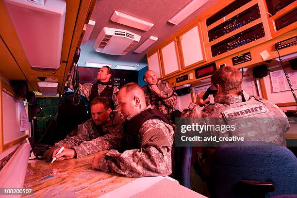 swat team inside command vehicle - military vehicle stock pictures, royalty-free photos & images