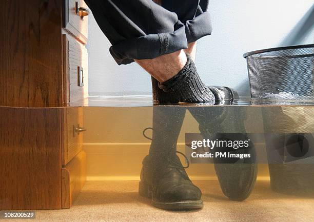 businessman's feet in flood - flood warning stock pictures, royalty-free photos & images