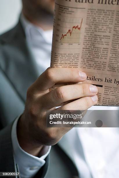 businessman reading financial newspaper - westers schrift stockfoto's en -beelden