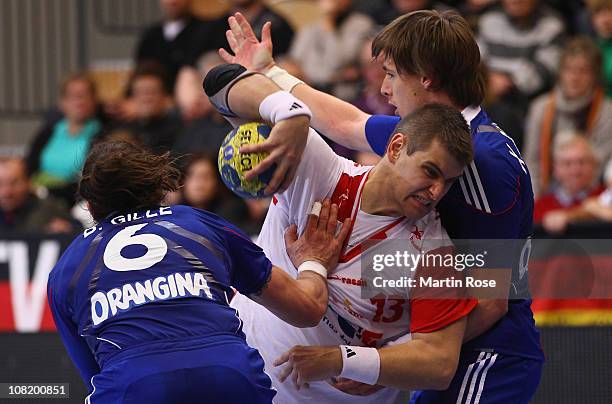 Bertrand Gille and Xavier Barachet of France is challenged by Julen Aguinagalde of Spain during the Men's Handball World Championship Group A match...