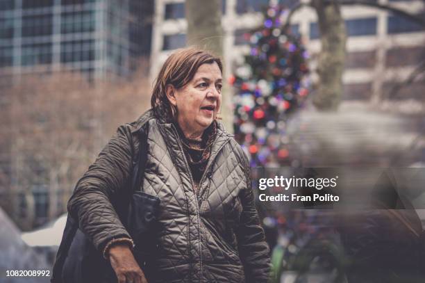 woman in the city at christmas. - bryant park christmas tree lighting stock pictures, royalty-free photos & images