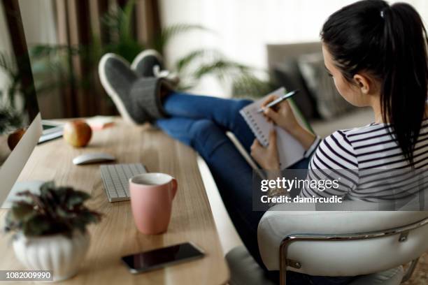 young woman working at home - list stock pictures, royalty-free photos & images